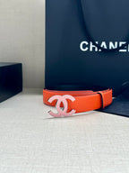 Orange Chanel belt with silver-tone CC buckle and smooth leather strap