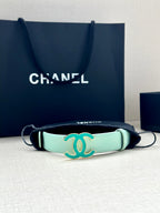 Mint Chanel belt bracelet-style strap with turquoise CC buckle and black cords.