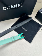 Mint Chanel belt with turquoise CC logo buckle, shown alongside a black belt.
