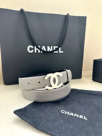 Gray leather Chanel belt with gold-tone CC logo buckle, laid flat