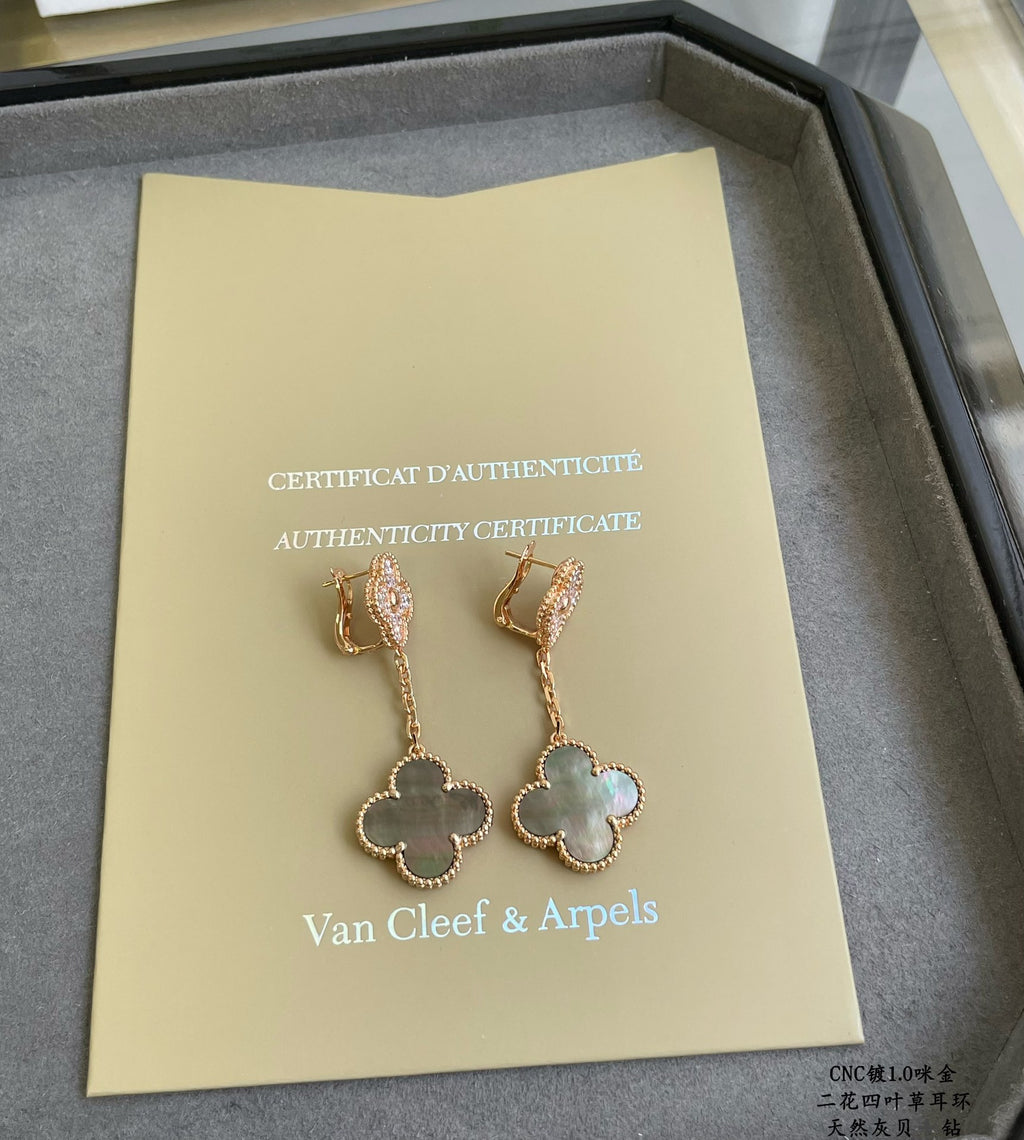 Authenticity certificate with Van Cleef & Arpels logo and gold clover drop earrings