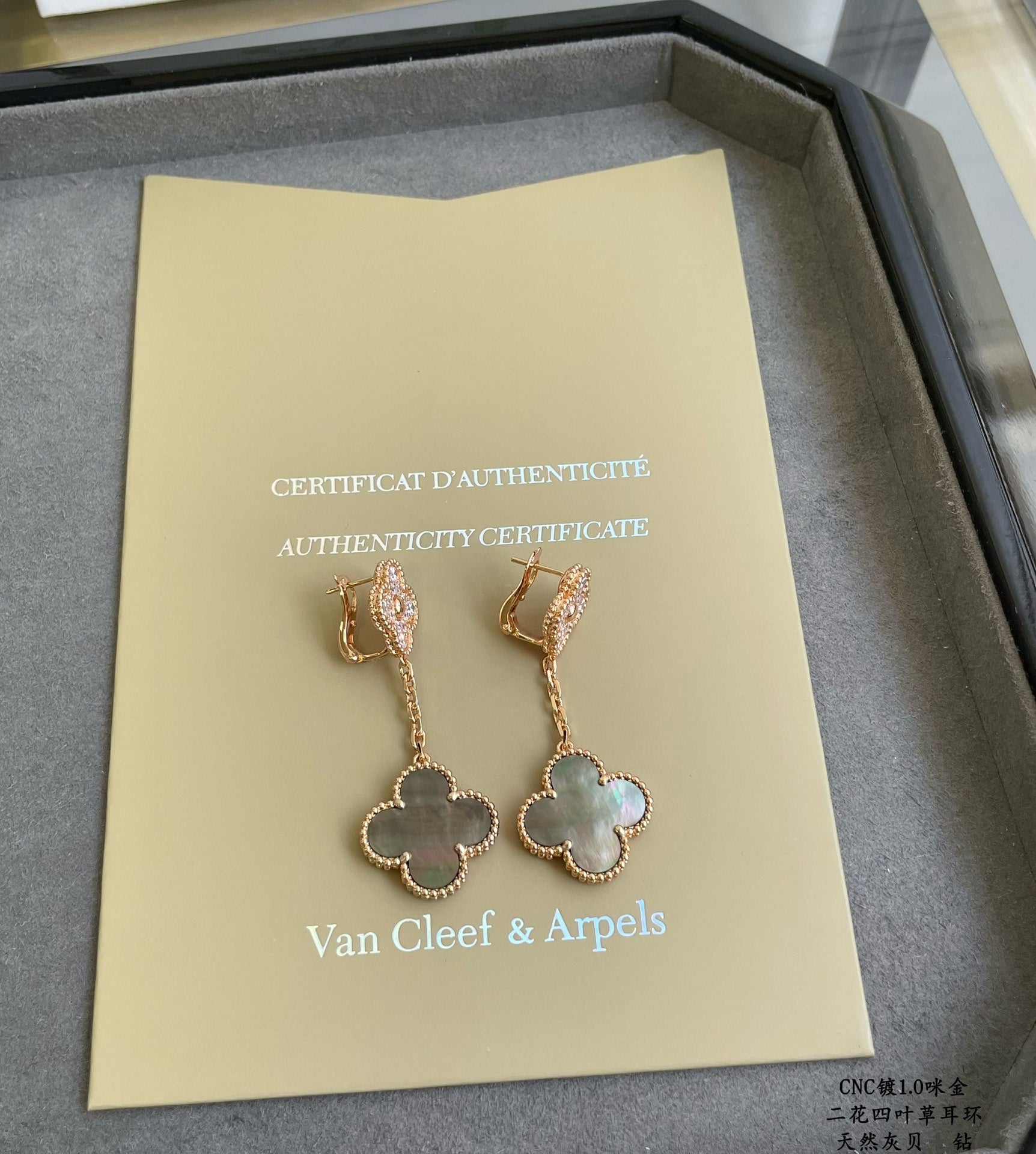 Authenticity certificate with Van Cleef & Arpels logo and gold clover drop earrings