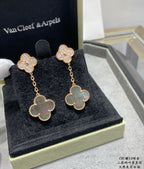 Gold clover drop earrings in display box with sparkling studs and pastel blue centers