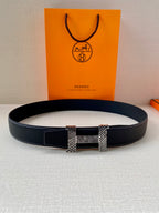 Leather belt with dark blue strap and square gold-toned buckle accents