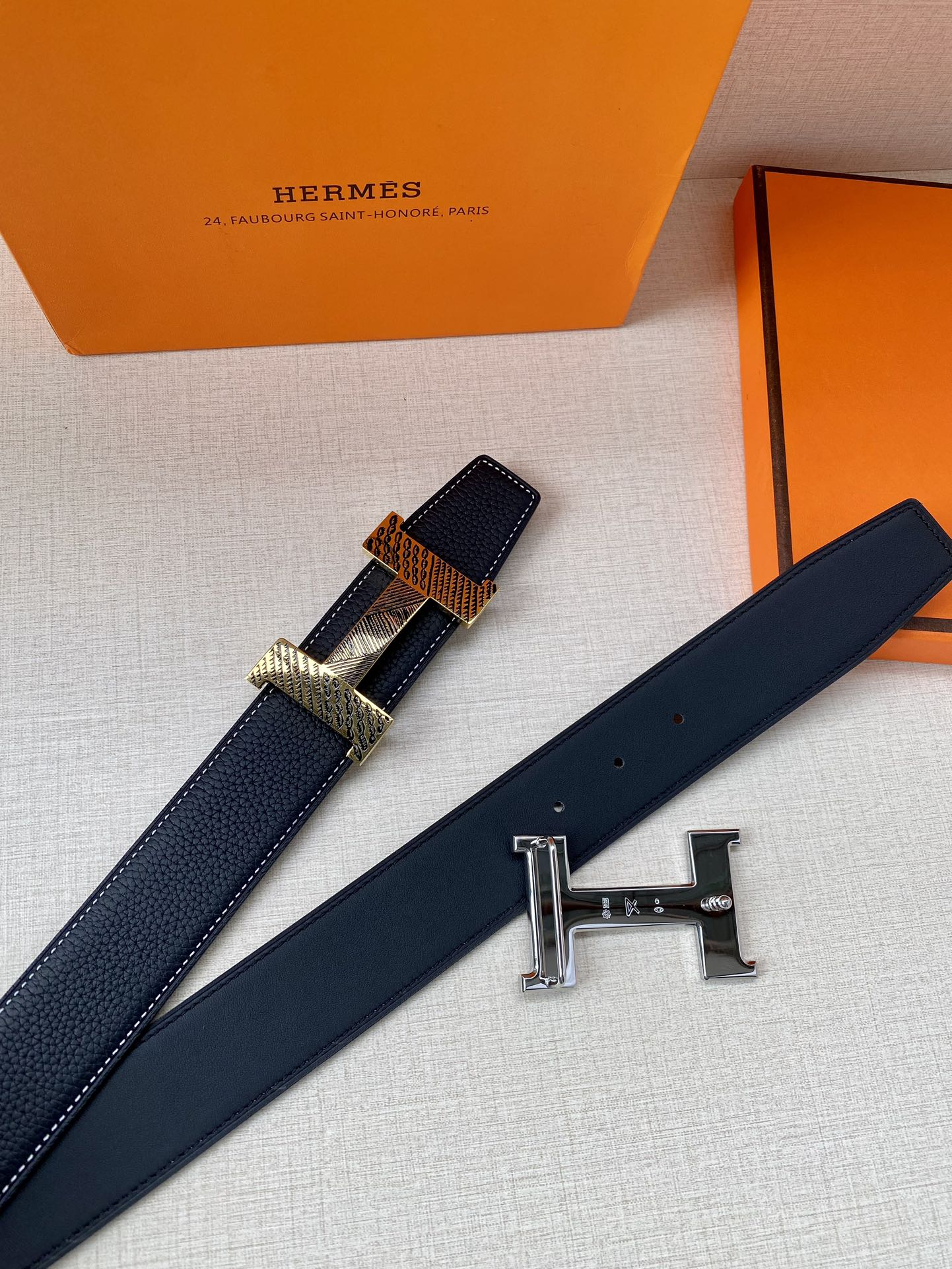 Leather belt with dark blue strap and silver-toned H buckle