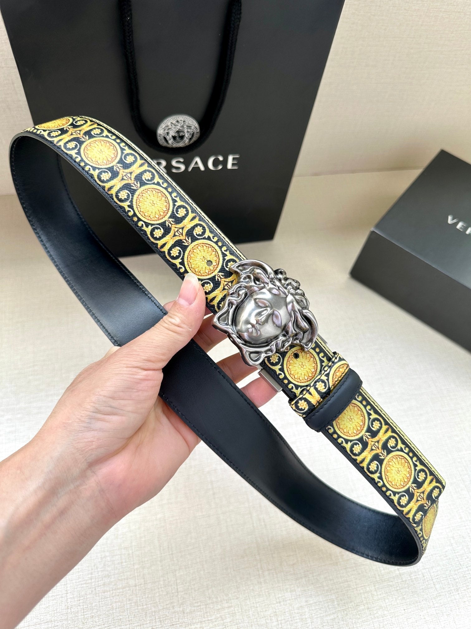 Navy patterned leather belt with gold oval motif and silver Medusa buckle