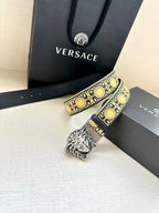 Navy leather belt with gold baroque pattern and silver Medusa buckle close-up