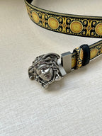 Navy leather belt with gold patterned strap and silver Medusa head buckle