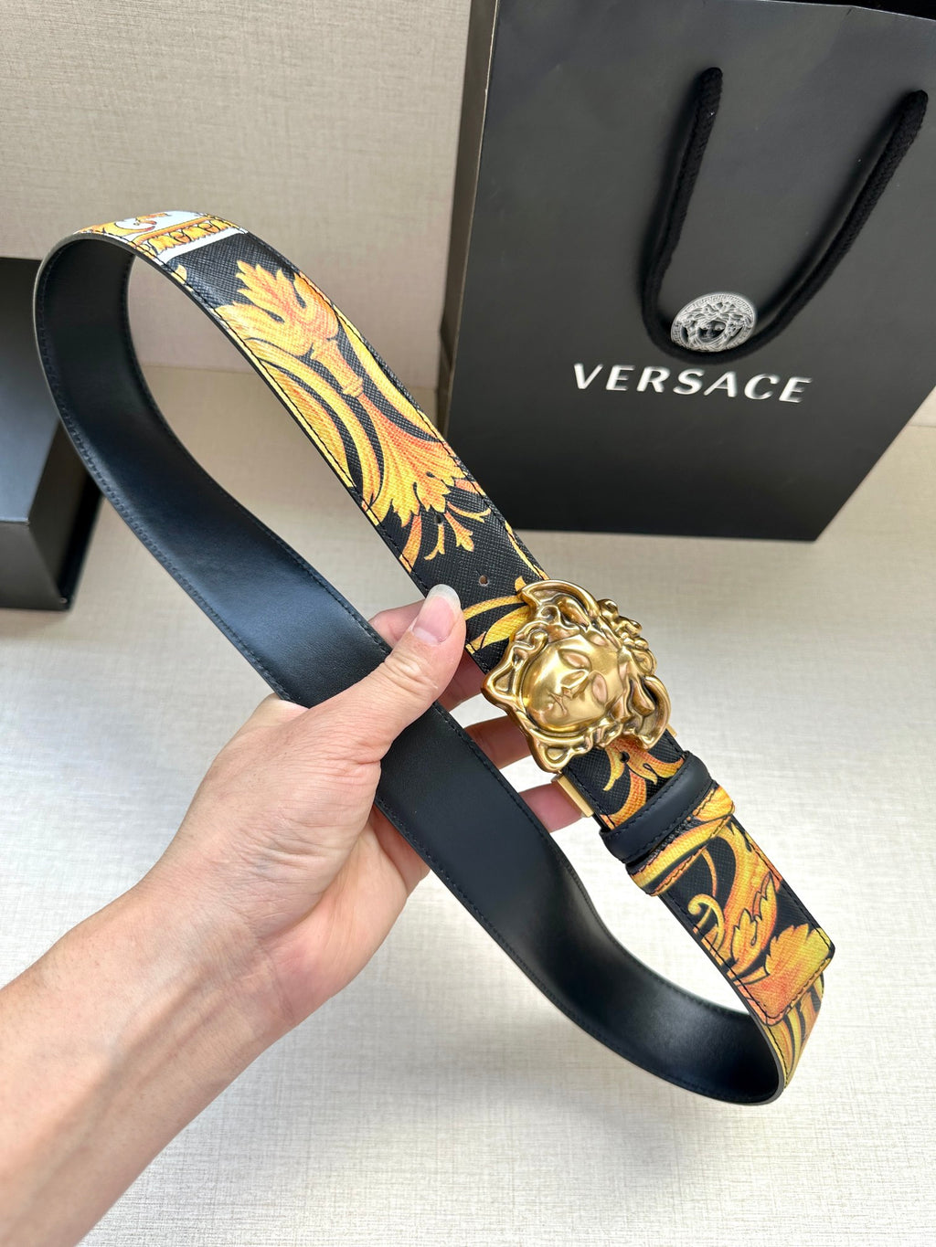 Versace belt with dark blue floral print strap and gold-toned Medusa head buckle