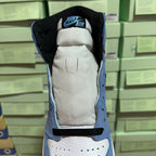 High-top sneaker heel opening with black lining, light blue collar, and white padding.