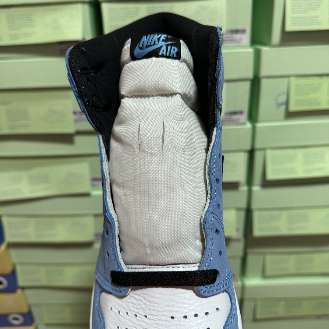 High-top sneaker heel opening with black lining, light blue collar, and white padding.