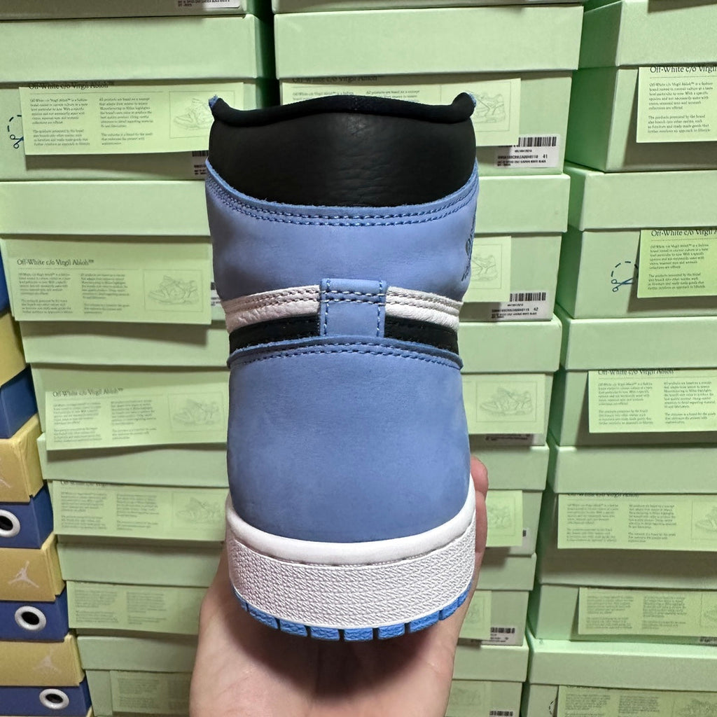 Back view of light blue high-top sneakers with black collar and white midsole.