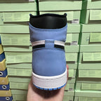 Back view of light blue high-top sneakers with black collar and white midsole.