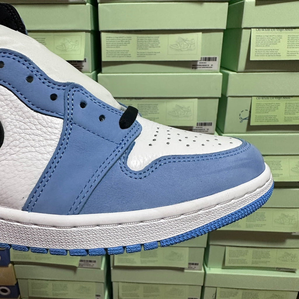 Light blue and white high-top sneakers with black swoosh and lace area detail.