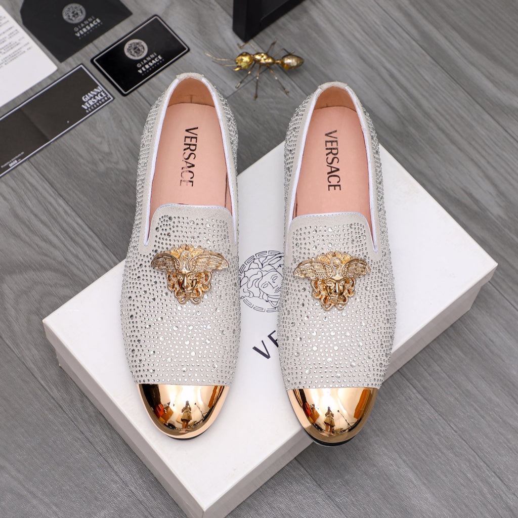 Luxury Versace loafers in white sparkle with gold crest embellishment and metallic toe