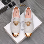 Luxury Versace loafers in white sparkle with gold crest embellishment and metallic toe