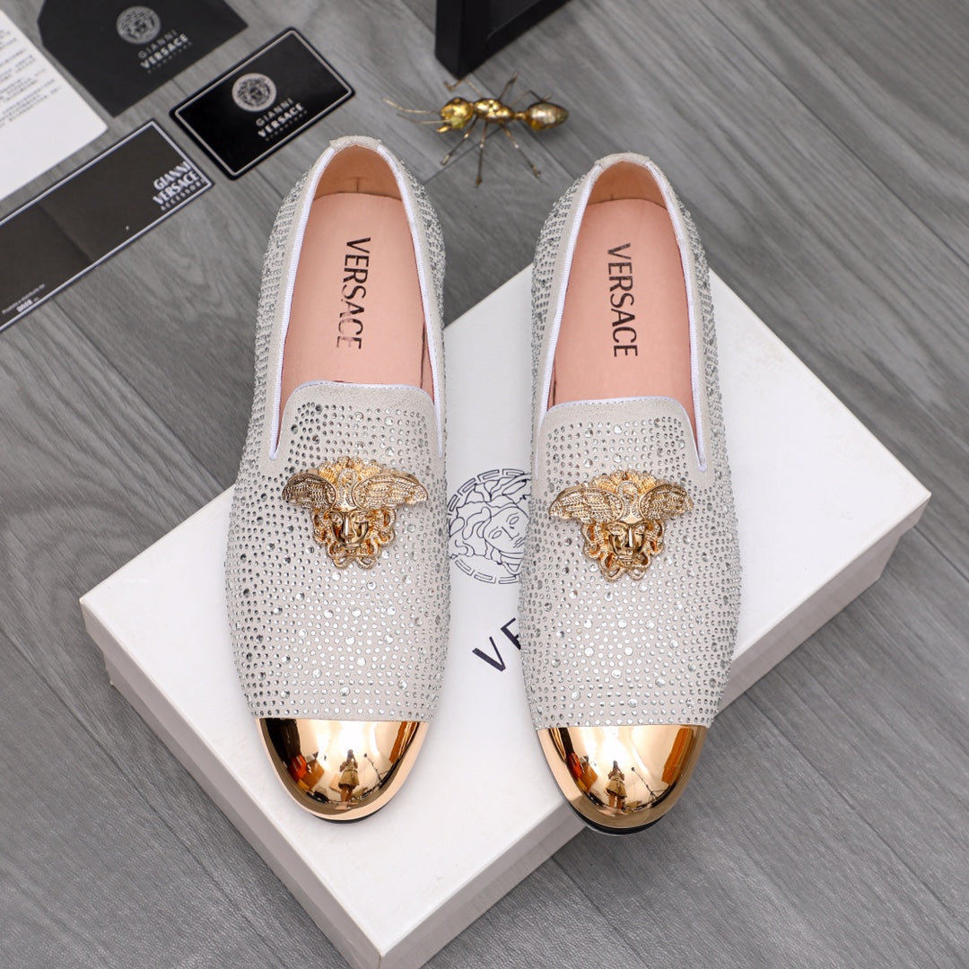 Luxury Versace loafers in white sparkle with gold crest embellishment and metallic toe
