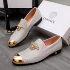 Luxury Versace loafers in white rhinestones with gold crest detail and rounded metallic toe