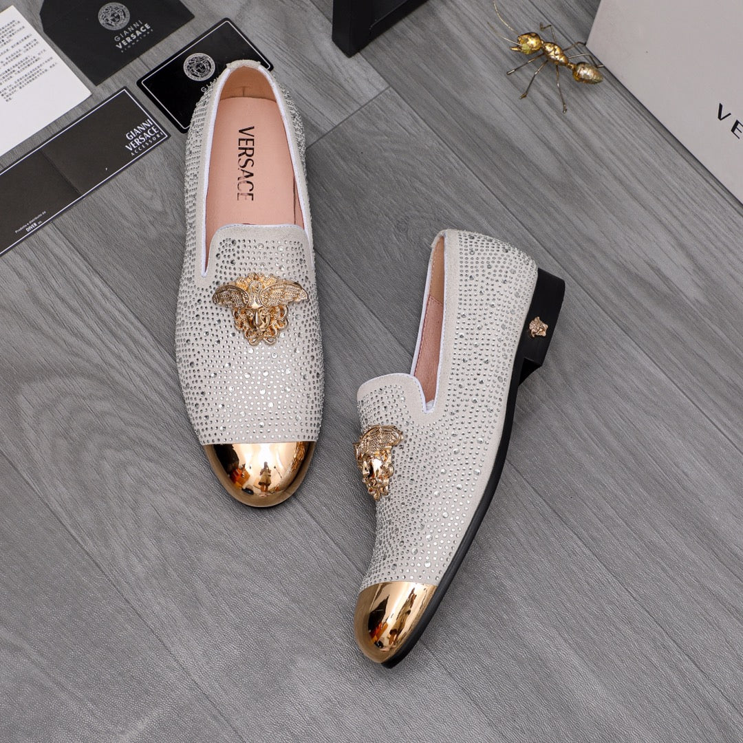 Luxury Versace loafers in white sparkle with gold crest ornament and metallic bottom trim