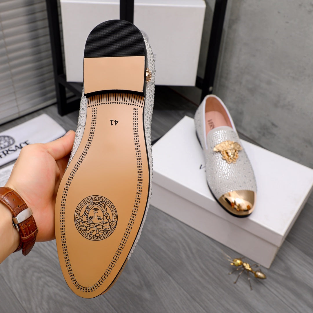 Luxury Versace loafers outsole view with brown leather insole and logo stamp