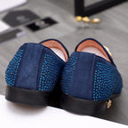Blue rhinestone slip-on loafers with gold heel accent and black rubber sole