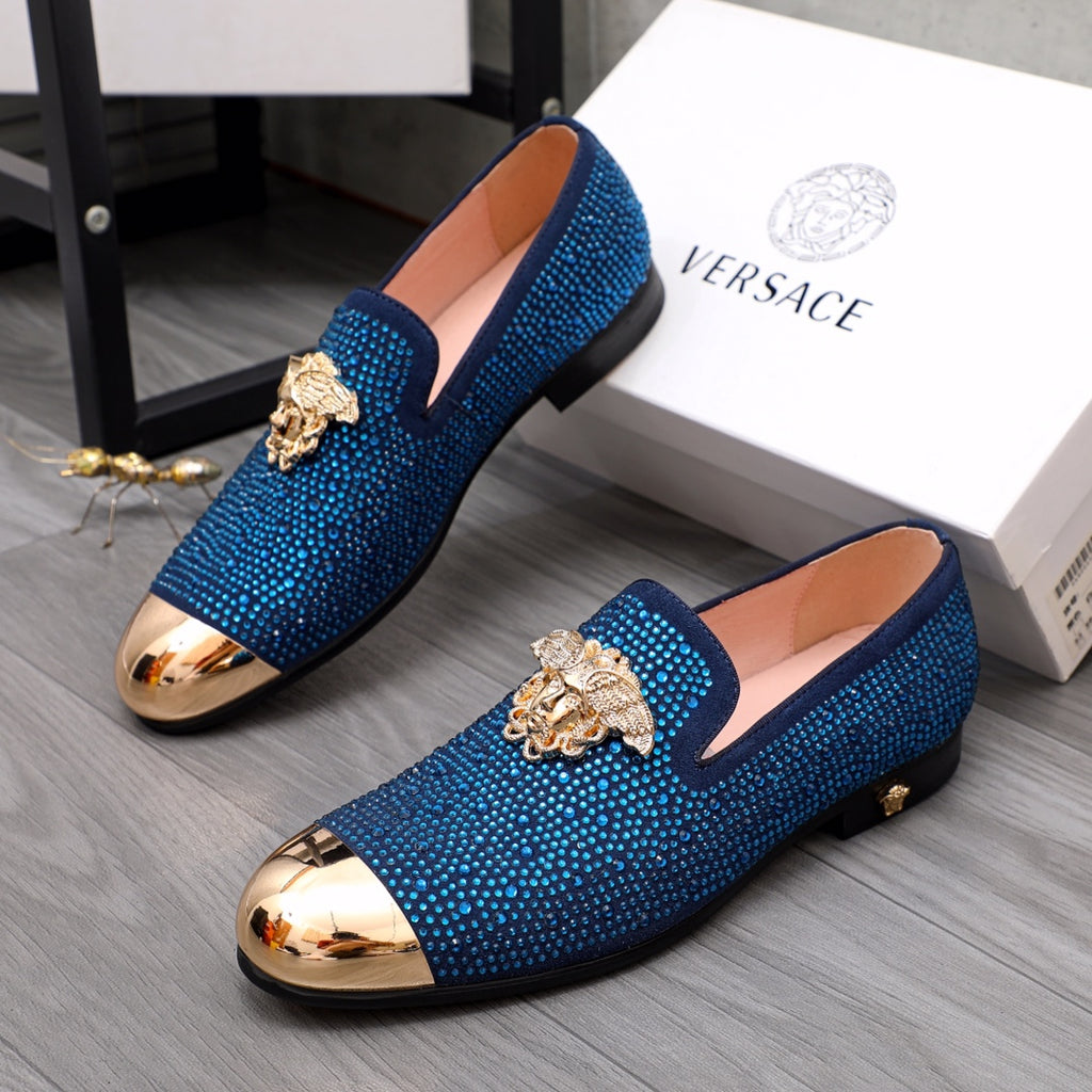 Blue rhinestone Versace loafers with gold lion emblem and metallic toe caps