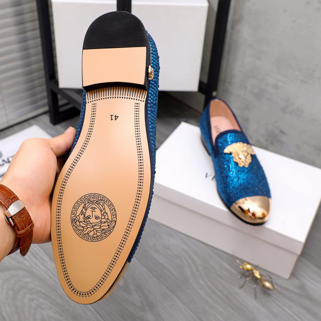 Loafer outsole with tan insole and logo, showing blue rhinestone upper underside