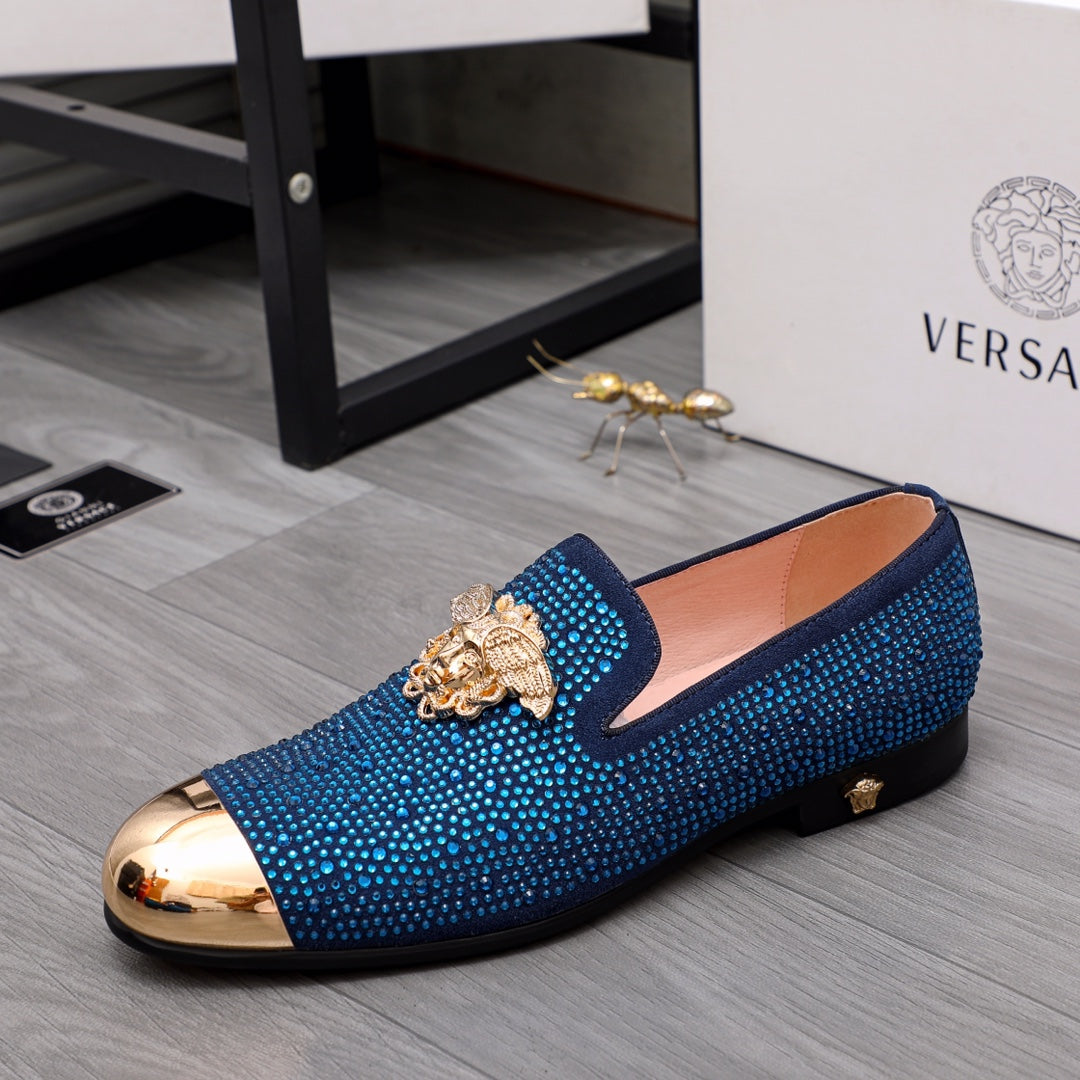 Blue rhinestone slip-on loafers with gold lion emblem and metallic toe cap