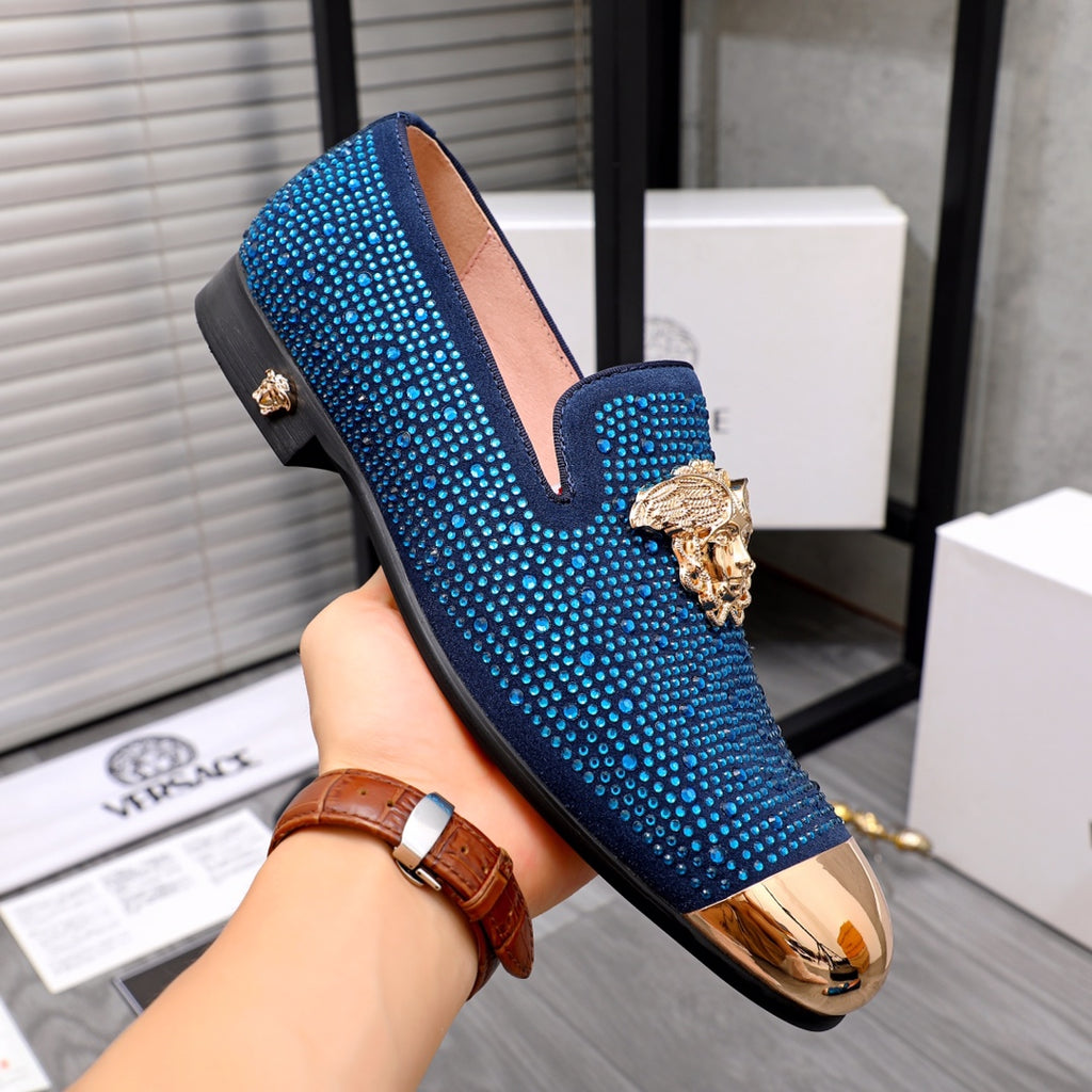 Blue rhinestone loafer with gold lion emblem and glossy metallic toe trim