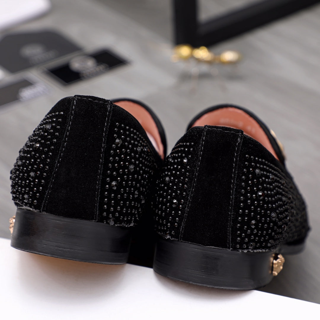 Back view of black glitter slip-on loafers with black rubber sole