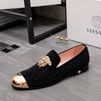 Black glitter slip-on loafers with gold-toned ornament and low heel