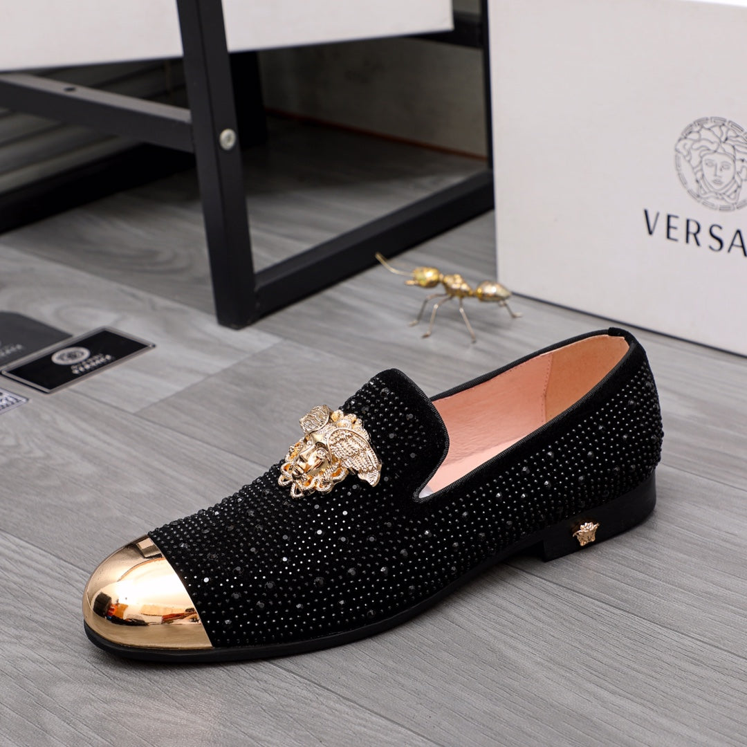 Black glitter slip-on loafers with gold-toned ornament and low heel