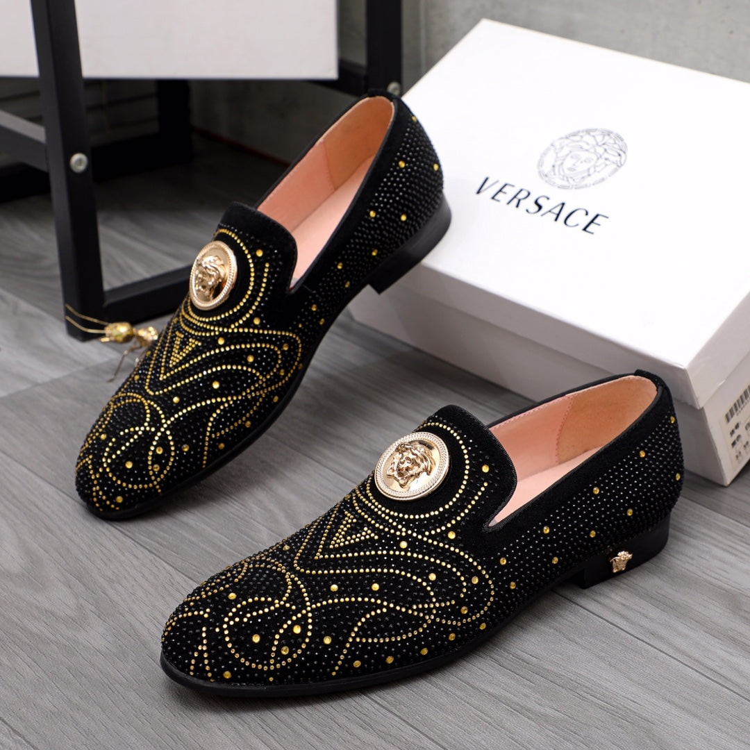 Pair of Versace black embellished loafers with gold crest buckle and studs