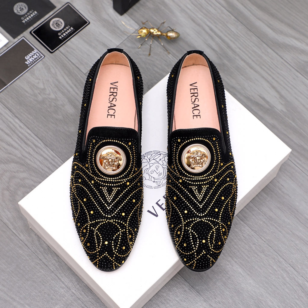 Versace black embellished slip-on loafers with gold studs and medallion detail