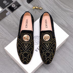 Versace black embellished slip-on loafers with gold studs and medallion detail