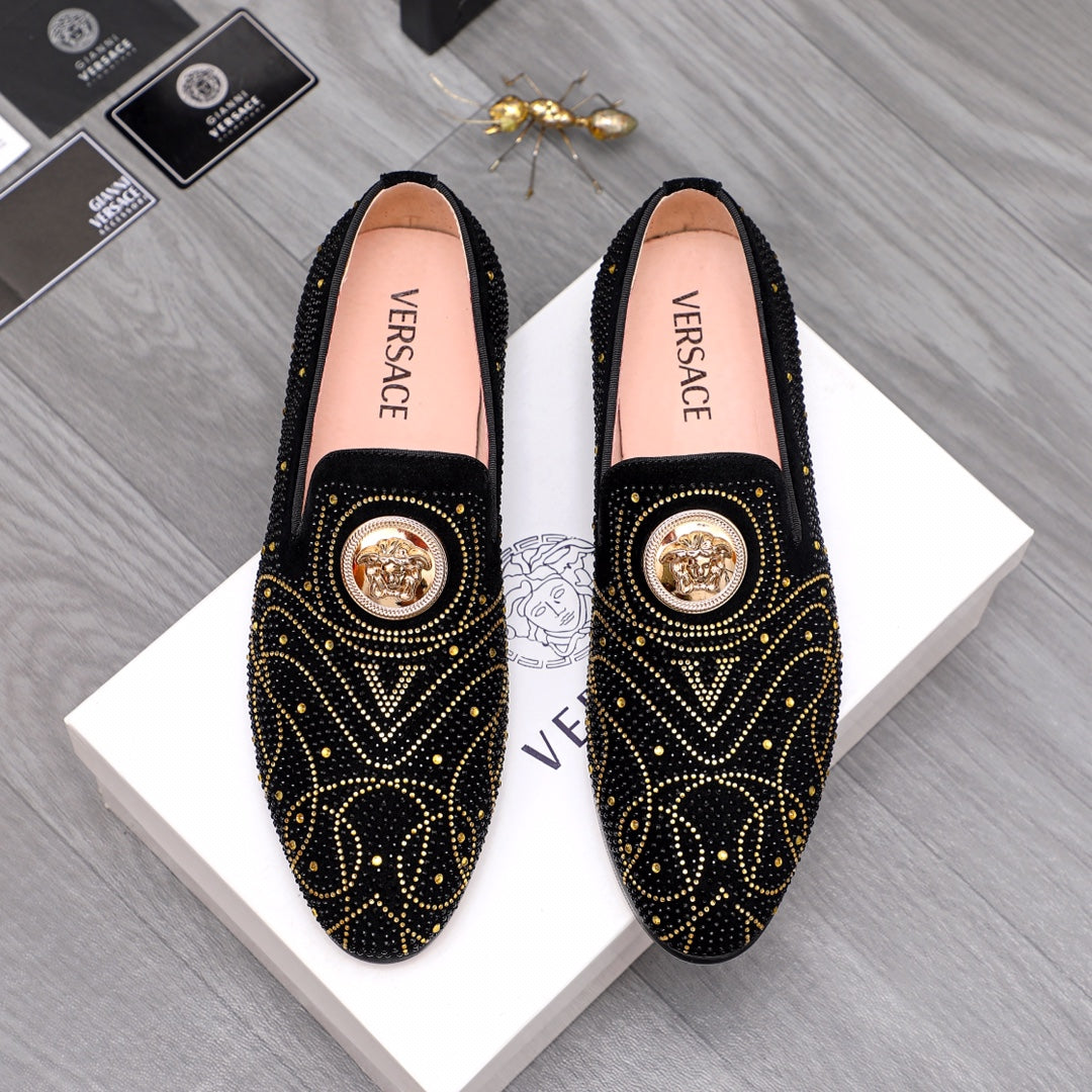 Versace black embellished slip-on loafers with gold studs and medallion detail