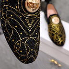 Versace black loafer close-up with gold stud swirl pattern and round crest badge