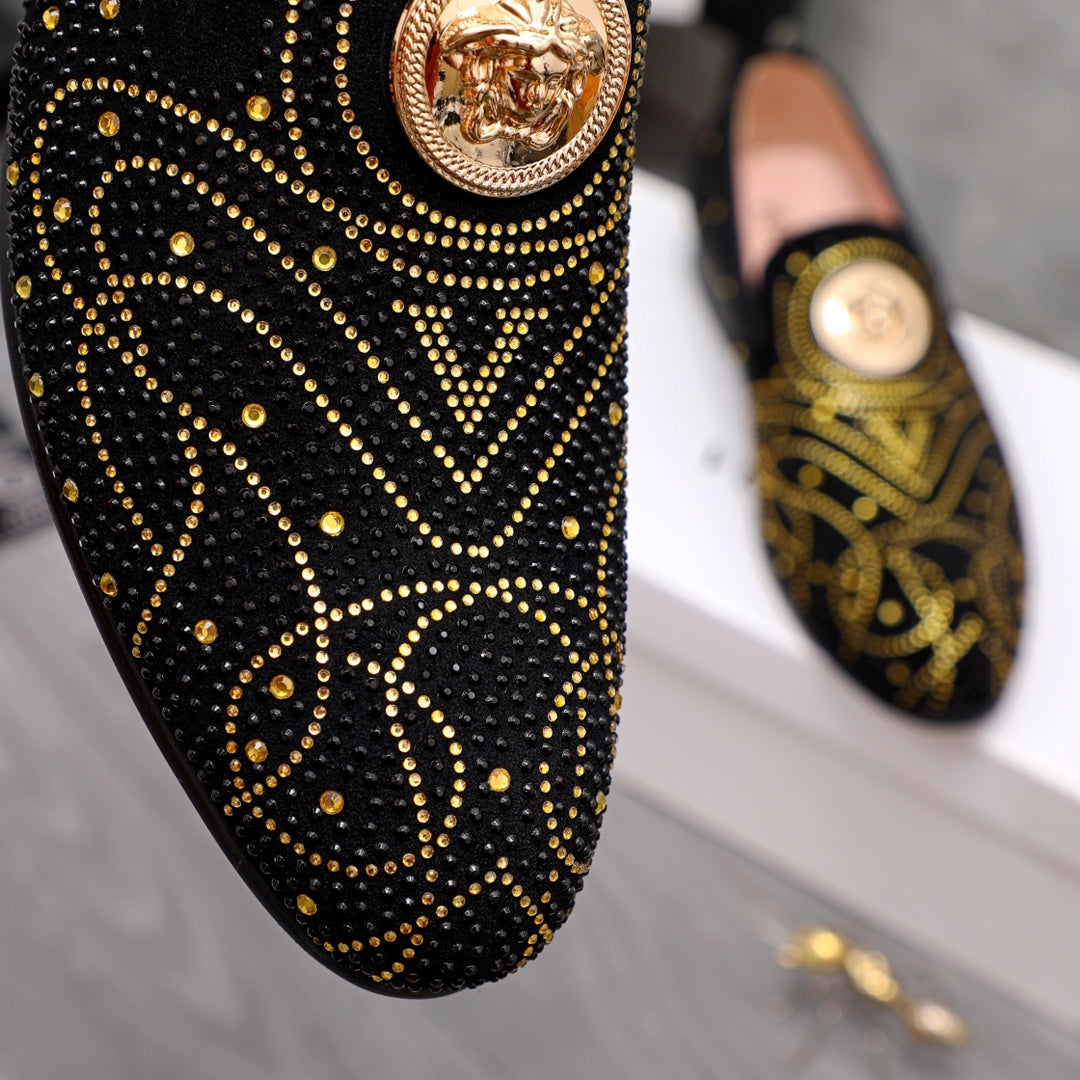 Versace black loafer close-up with gold stud swirl pattern and round crest badge