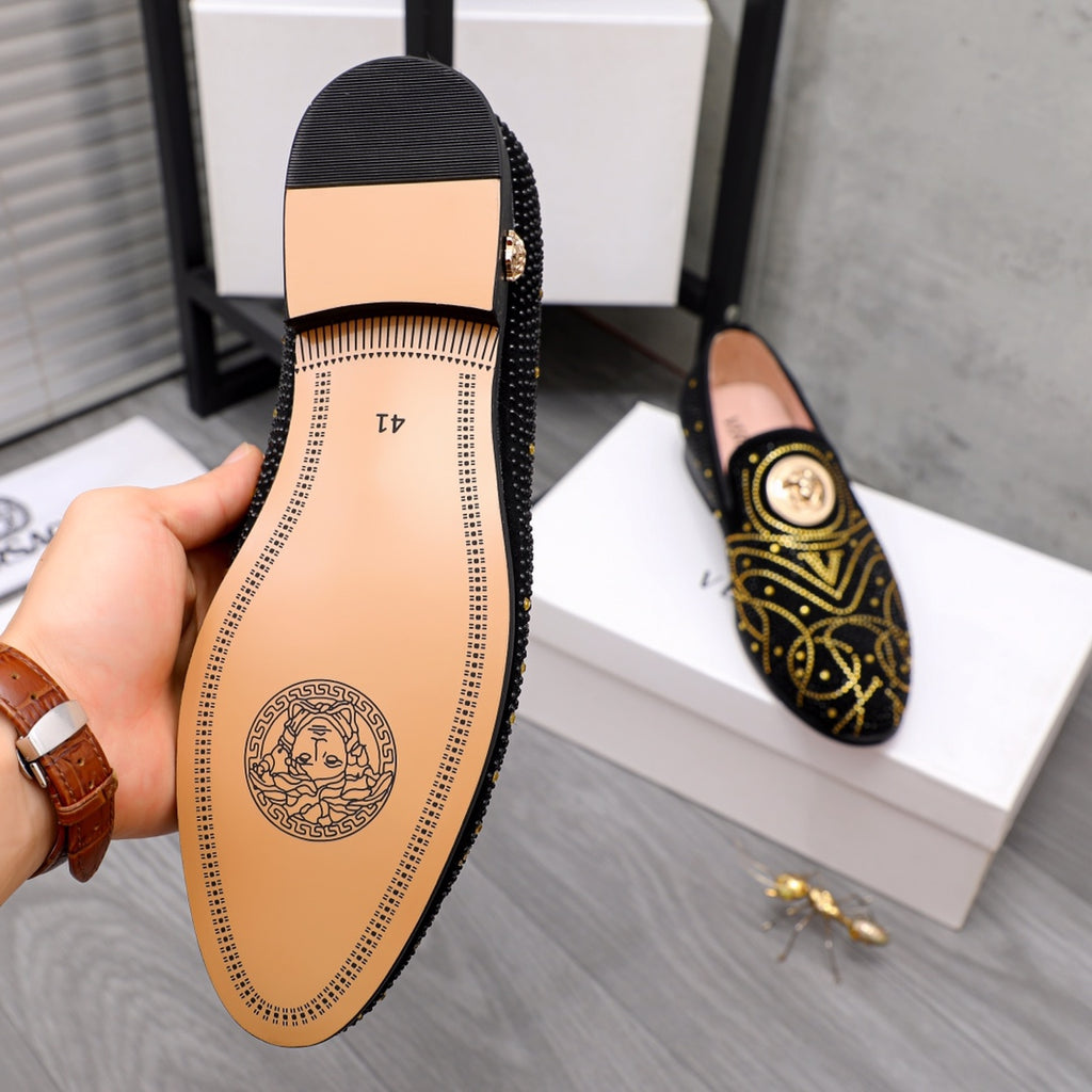 Versace black loafer interior view with tan insole and logo emblem on heel