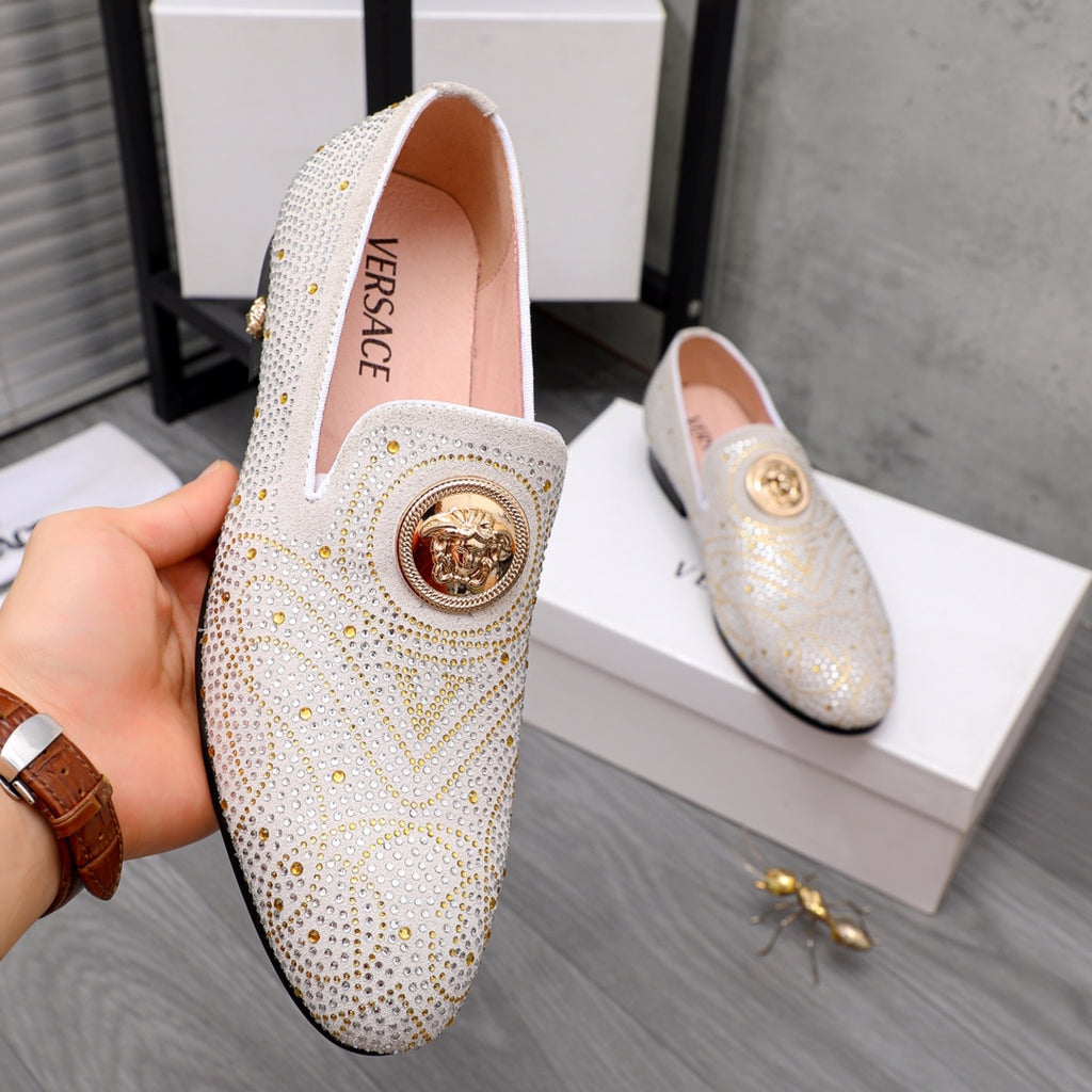White jeweled slip-on loafer with gold round medallion on the vamp, front view