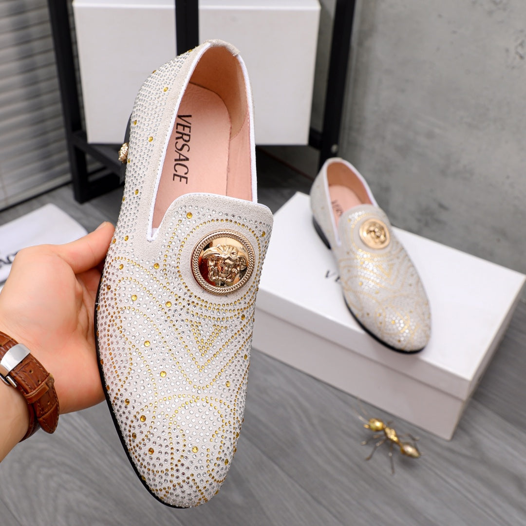 White jeweled slip-on loafer with gold round medallion on the vamp, front view