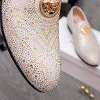 Close-up of white jeweled slip-on loafer with gold round medallion on the vamp