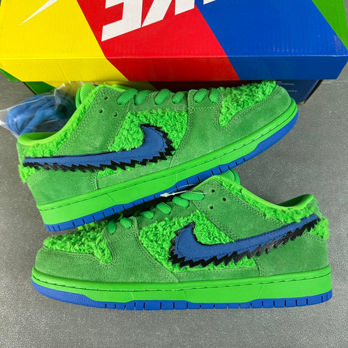 Neon green low-top sneakers with blue swoosh and textured upper, lace-up design
