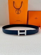 Blue leather belt with silver H buckle, shown with full loop shape.