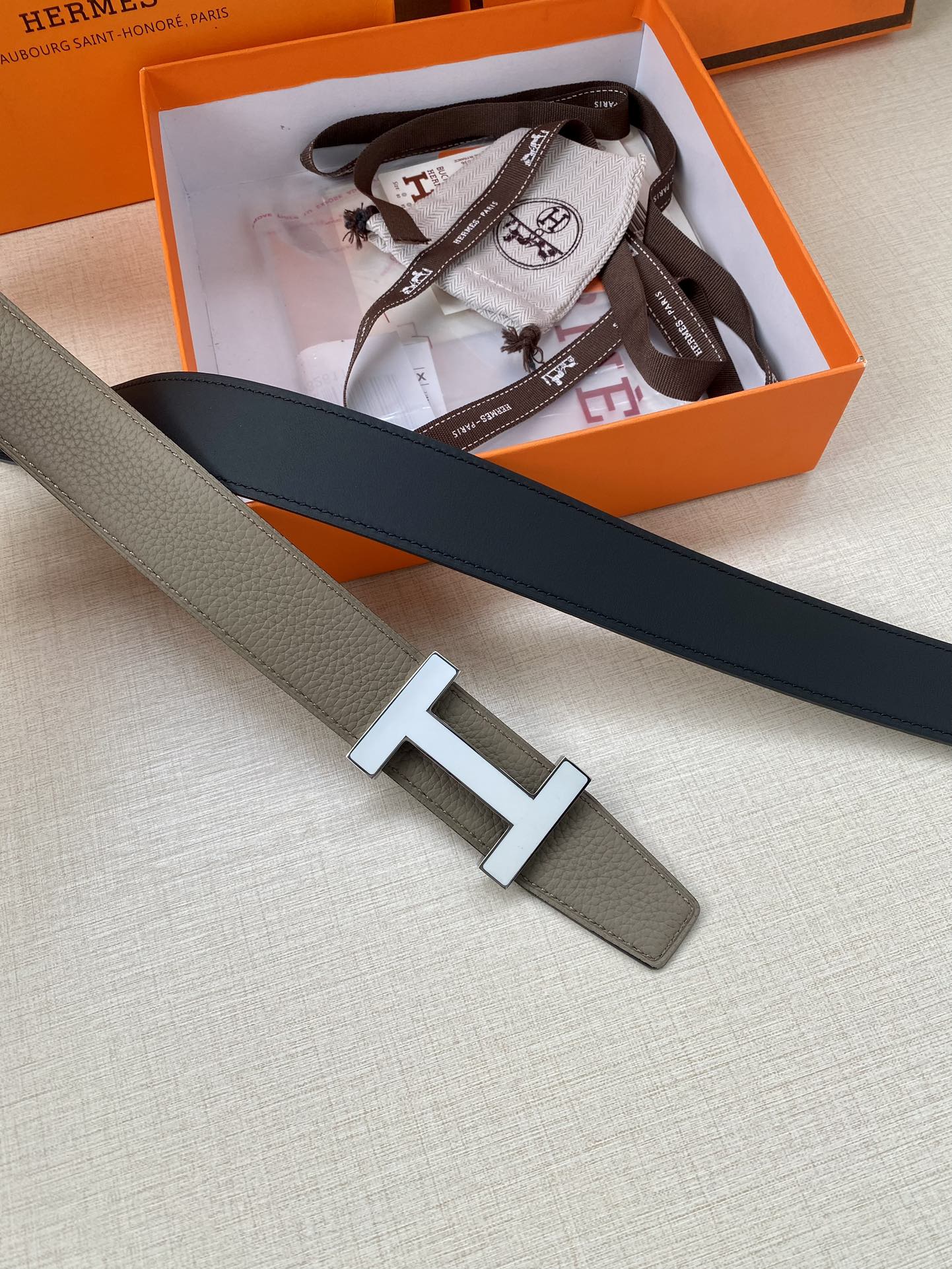 Hermes reversible leather belt with silver H buckle, gray with dark navy trim