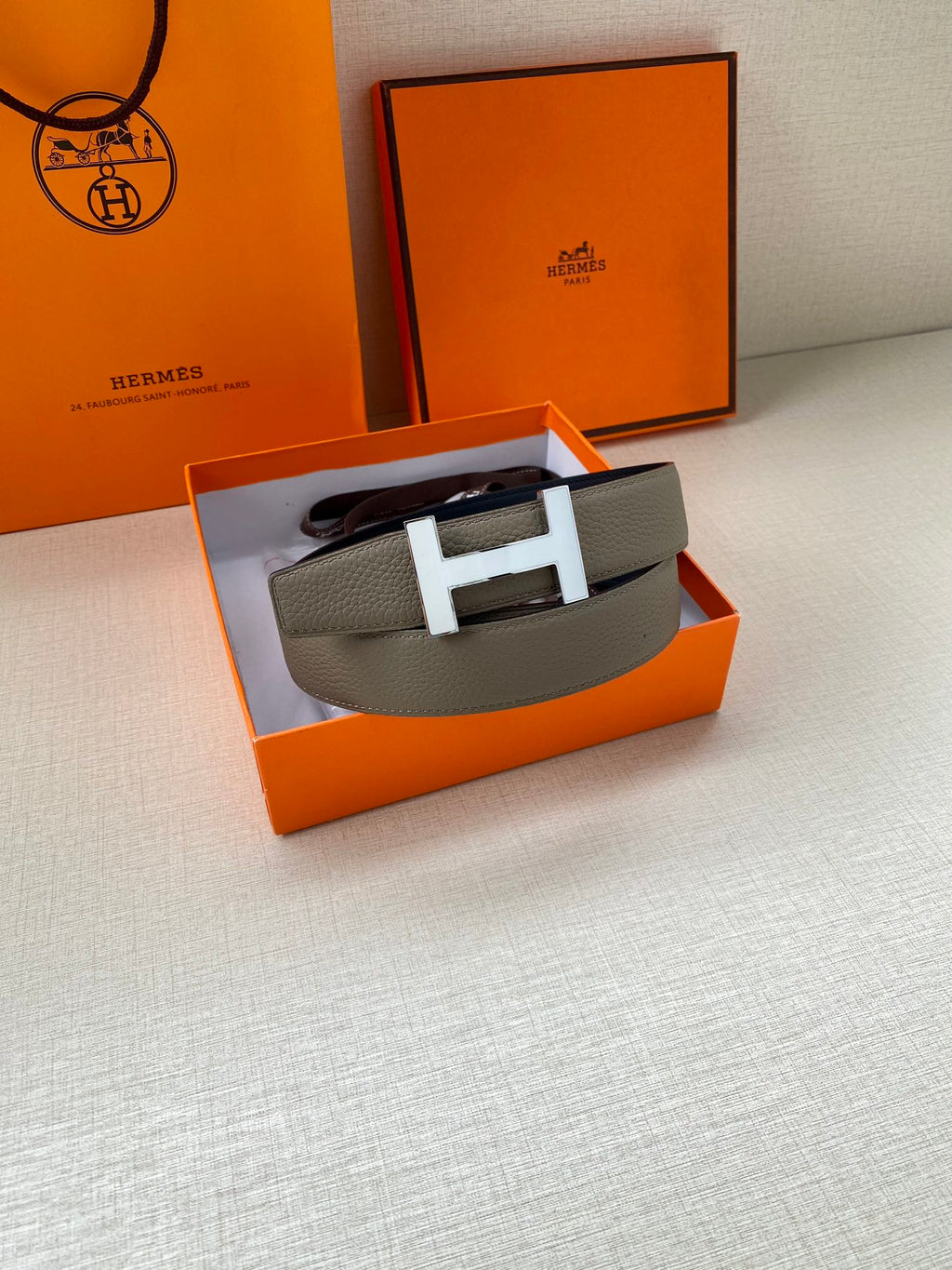 Hermes leather belt with silver H buckle, textured gray strap