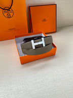 Hermes leather belt with silver H buckle, textured gray strap