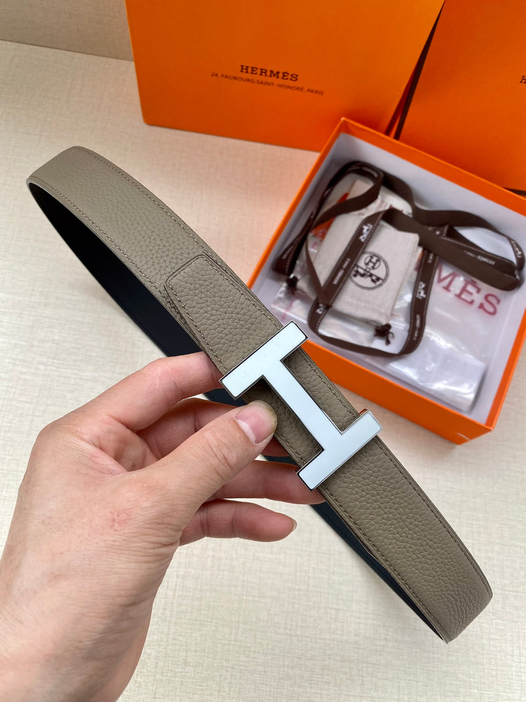 Hermes leather belt with silver H buckle, textured gray strap