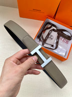 Hermes leather belt with silver H buckle, textured gray strap