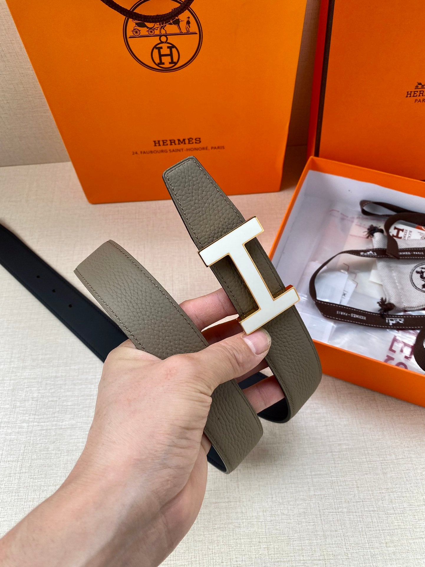 Hermes leather belt with silver H buckle, textured gray strap detail